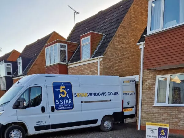 A Sign Written 5 Star Fitters Van Outside A House